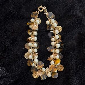 JCrew necklace with pearls and tortoise charms and stars
